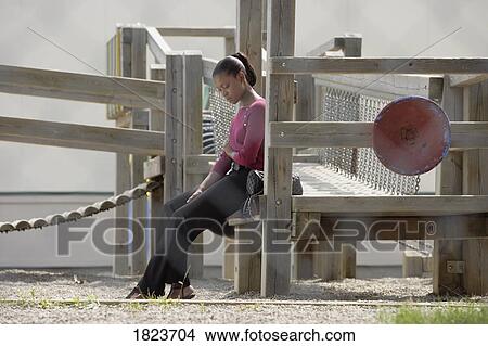 Woman alone in a playground View Large Photo Image Picture - Woman alone in a playground. Fotosearch