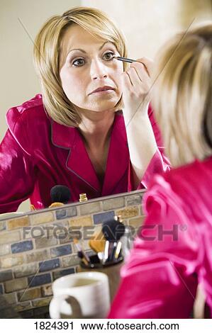 Stock Image - Woman applying makeup. Fotosearch