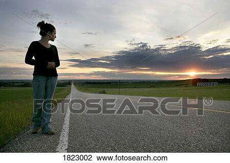 Woman beside the road View Large Photo Image Stock Image - Woman beside the road. Fotosearch
