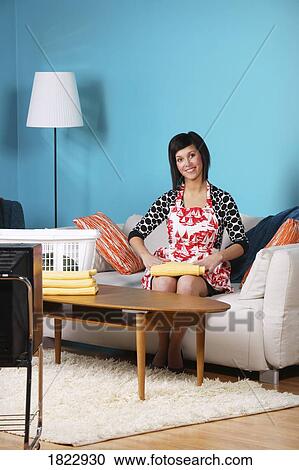 Woman folding laundry View Large Photo Image Stock Image - Woman folding laundry. Fotosearch
