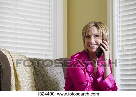 Woman in pajamas and on the phone View Large Photo Image Stock Image - Woman in pajamas and on the phone. Fotosearch