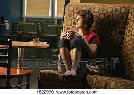 Stock Image - Woman in restaurant. Fotosearch