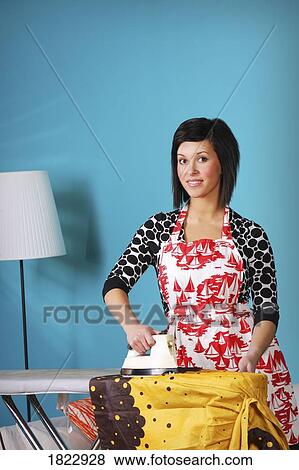 Woman ironing clothes at home View Large Photo Image Stock Photo - Woman ironing clothes at home. Fotosearch