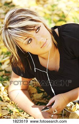 Stock Photo - Woman listening to music. Fotosearch