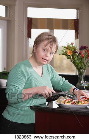 Stock Image - Woman preparing food. Fotosearch