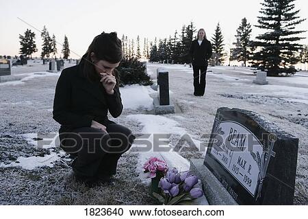 Woman visiting a grave View Large Photo Image Stock Image - Woman visiting a grave. Fotosearch