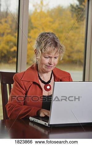 Stock Photograph - Woman working on computer. Fotosearch