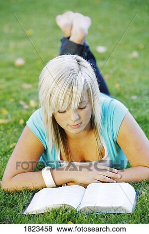 Stock Photo - Young girl reading her Bible. Fotosearch