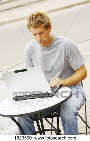 Young man with laptop computer View Large Photo Image Stock Image - Young man with laptop computer. Fotosearch