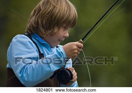 Stock Image - Boy fly fishing . Fotosearch