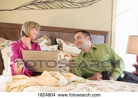 Picture - Couple lounging in the morning. Fotosearch