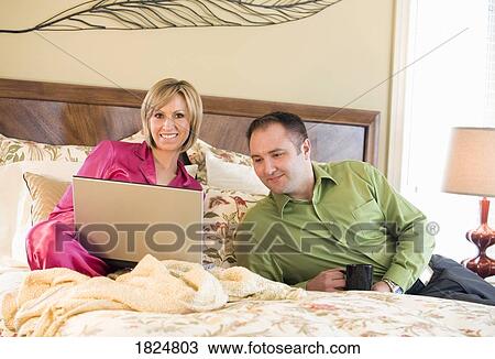 Stock Image - Couple lounging in the morning. Fotosearch