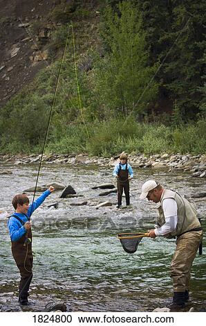 Father and sons fly fishing in mountain river, Nordegg, Alberta, Canada View Large Photo Image Stock Image - Father and sons fly fishing in mountain river, Nordegg, Alberta, Canada . Fotosearch