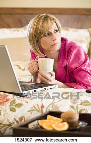 Stock Photo - Woman with laptop computer. Fotosearch