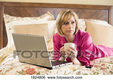 Stock Photograph - Woman with laptop computer. Fotosearch