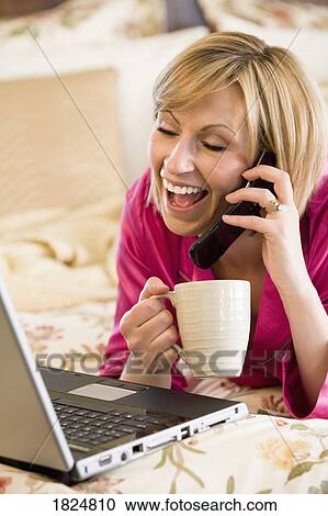 Woman working on computer and on the phone View Large Photo Image Stock Image - Woman working on computer and on the phone. Fotosearch