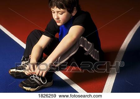 A boy tying his laces View Large Photo Image Stock Photo - A boy tying his laces. Fotosearch