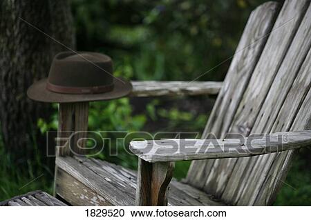 A hat on an adirondack chair View Large Photo Image Stock Image - A hat on an adirondack chair. Fotosearch