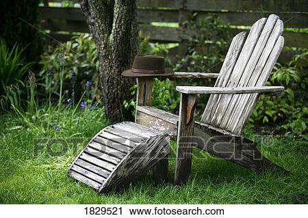 Stock Image - A hat on an adirondack chair. Fotosearch
