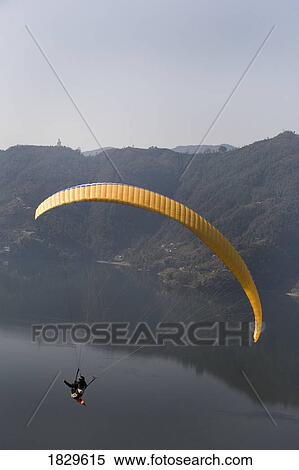 A man paragliding, Annapurna region, Himalayas near Pokhara, Nepal over Phewa Lake View Large Photo Image Stock Photography - A man paragliding, Annapurna region, Himalayas near Pokhara, Nepal over Phewa Lake. Fotosearch
