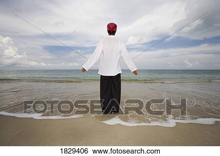 A man with arms outstretched on a beach in Koh Lanta, Thailand View Large Photo Image Stock Photograph - A man with arms outstretched on a beach in Koh Lanta, Thailand. Fotosearch