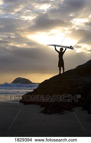 A surfer on Muriwai Beach, New Zealand View Large Photo Image Picture - A surfer on Muriwai Beach, New Zealand. Fotosearch