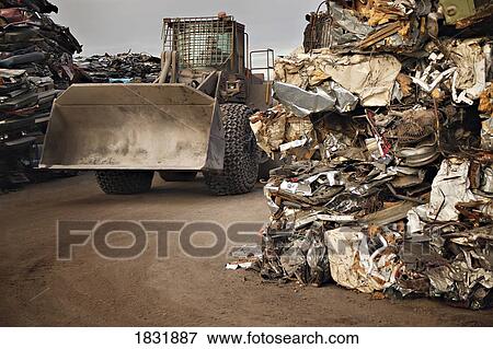 A tractor driving through stacks of compacted rubbish View Large Photo Image Stock Photo - A tractor driving through stacks of compacted rubbish. Fotosearch