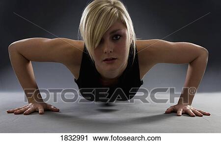 A woman doing pushups View Large Photo Image Stock Image - A woman doing pushups. Fotosearch