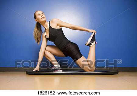 Stock Image - A woman stretching. Fotosearch