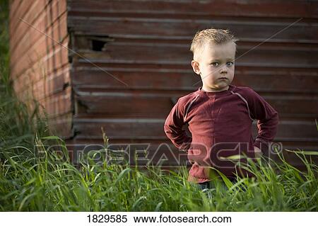 A young boy in a grassy field View Large Photo Image Stock Photography - A young boy in a grassy field. Fotosearch