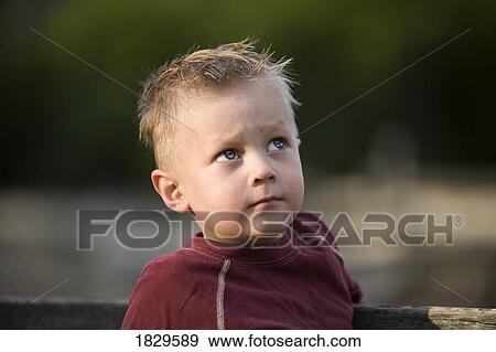 Stock Photo - A young boy's inquisitive eyes. Fotosearch