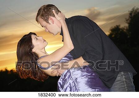 Stock Image - A Young Couple About To Kiss. Fotosearch