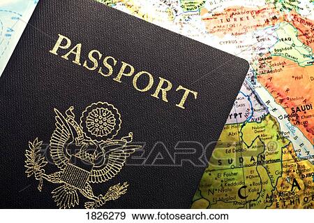 Stock Photo - American Passport laid over a map. Fotosearch