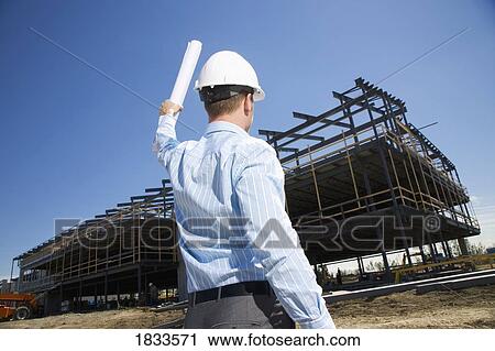 Architect overlooking building site View Large Photo Image Stock Image - Architect overlooking building site. Fotosearch