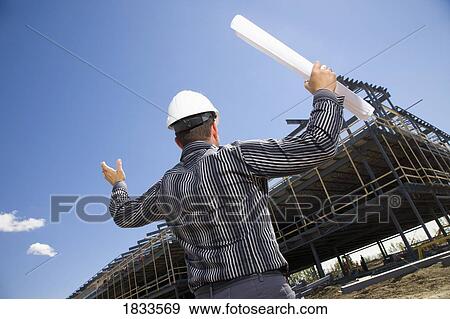 Stock Photo - Architect overlooking building site. Fotosearch