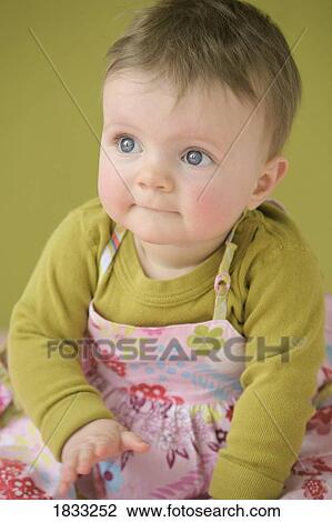Stock Image - Baby girl in dress. Fotosearch