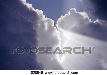 Beams of Light coming through hole in clouds View Large Photo Image Stock Photograph - Beams of Light coming through hole in clouds. Fotosearch