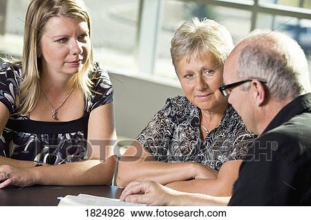 Stock Photograph - Bible study with three people. Fotosearch