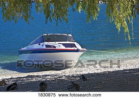 Stock Photography - Boat on sandy beach, Lake Wakatipu, New Zealand. Fotosearch