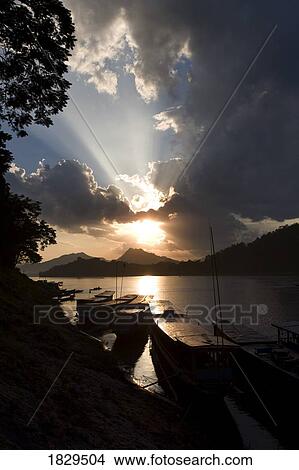 Boats at sunset in Mekong River at Luang Prabang, Laos, Asia View Large Photo Image Picture - Boats at sunset in Mekong River at Luang Prabang, Laos, Asia . Fotosearch