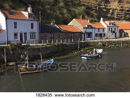 Boats moored on river, Staithes, Yorkshire, England View Large Photo Image Stock Photography - Boats moored on river, Staithes, Yorkshire, England. Fotosearch
