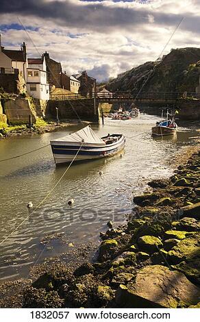 Boats On A River, Staithes, North Yorkshire, England View Large Photo Image Stock Photo - Boats On A River, Staithes, North Yorkshire, England. Fotosearch