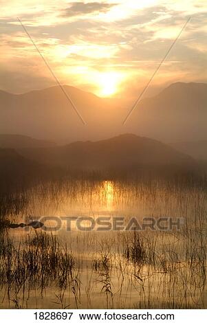 Stock Photo - Bog Lake near Clifden at sunrise with 12 Bens, Galway, Ireland. Fotosearch