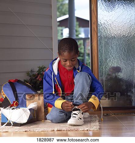 Boy (5-6) getting dressed View Large Photo Image Stock Photo - Boy (5-6) getting dressed. Fotosearch