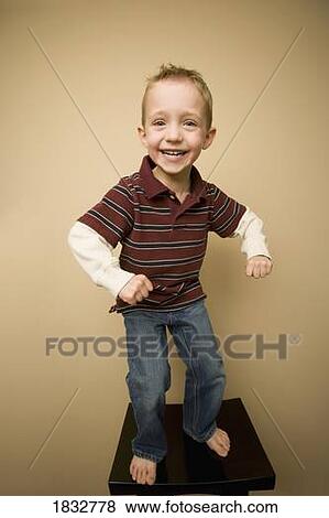 Boy balancing on stool View Large Photo Image Stock Photo - Boy balancing on stool. Fotosearch