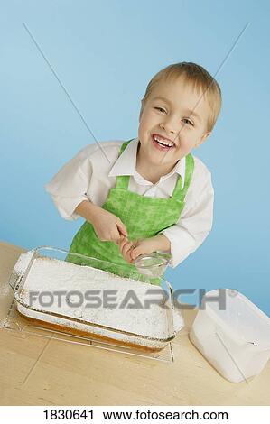 Boy icing a cake View Large Photo Image Stock Image - Boy icing a cake. Fotosearch