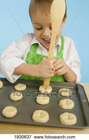 Boy making cookies View Large Photo Image Stock Photo - Boy making cookies. Fotosearch