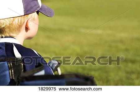 Boy wearing baseball cap, outdoors, rear view View Large Photo Image Stock Photography - Boy wearing baseball cap, outdoors, rear view. Fotosearch