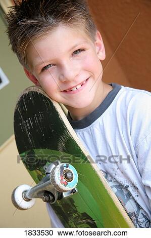 Stock Image - Boy with skateboard. Fotosearch