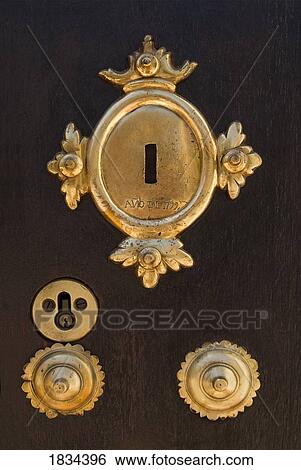 Brass key plates on wooden door  View Large Photo Image Stock Photograph - Brass key plates on wooden door . Fotosearch